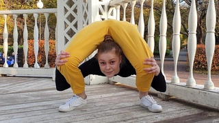 Contortion workout. Circus girl in the park. Acrobatics training routines.